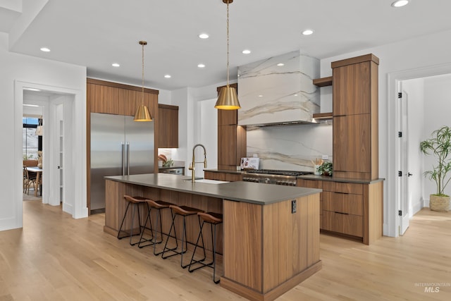 kitchen featuring open shelves, built in refrigerator, custom exhaust hood, modern cabinets, and a sink