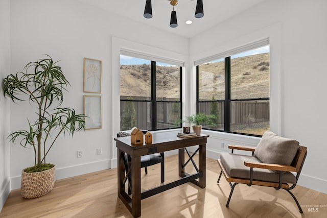 office area with recessed lighting, light wood-type flooring, baseboards, and a mountain view