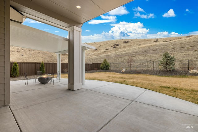 view of patio / terrace with a fenced backyard and an outdoor fire pit