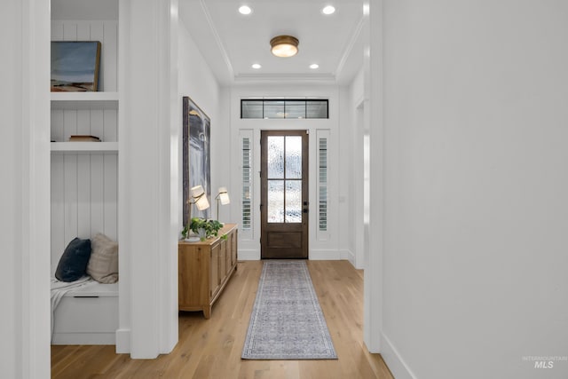 foyer with recessed lighting, light wood-style flooring, baseboards, and ornamental molding