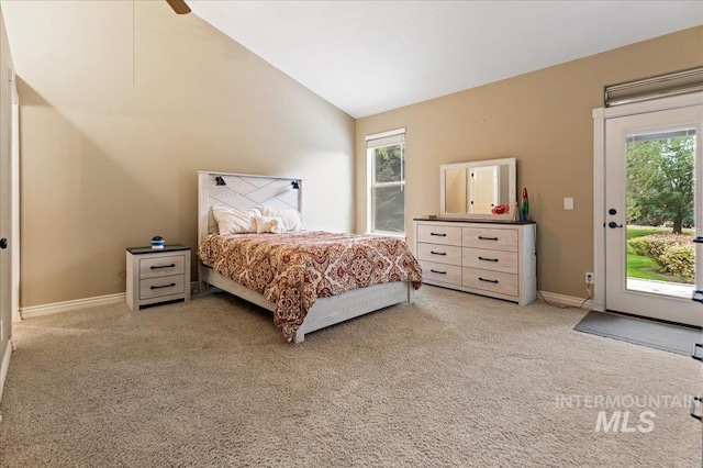 bedroom featuring lofted ceiling, access to exterior, and light carpet