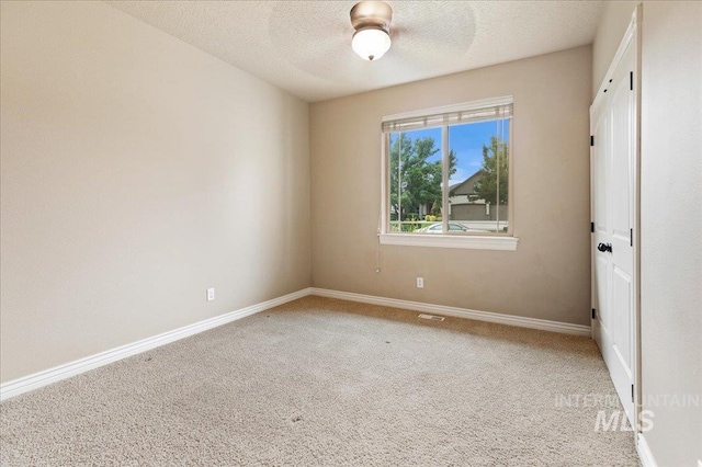 unfurnished bedroom with carpet floors and a textured ceiling