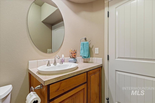 bathroom with vanity and toilet