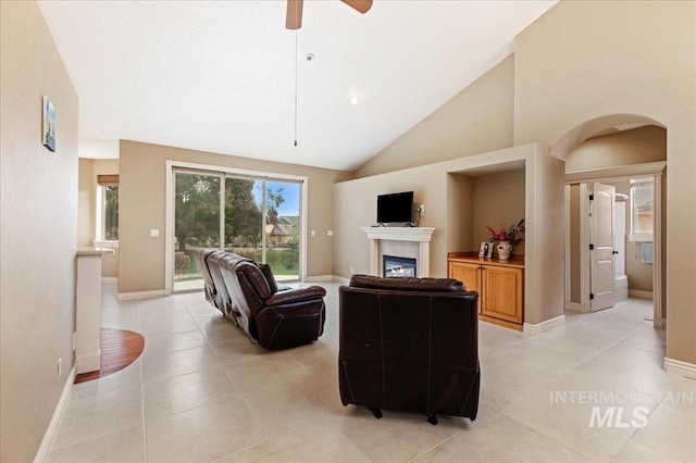 tiled living room with high vaulted ceiling and ceiling fan