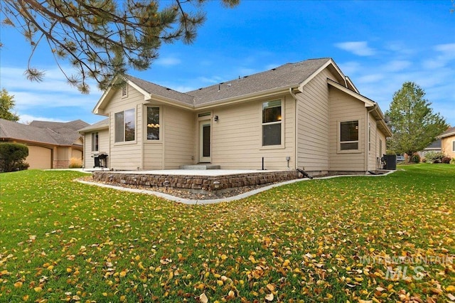 back of house with a lawn