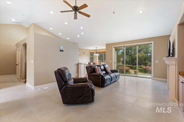 living room featuring lofted ceiling, light tile patterned floors, and ceiling fan