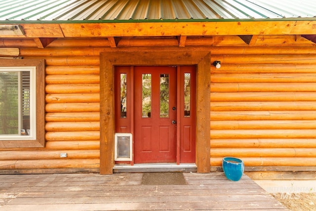 doorway to property featuring metal roof