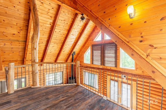 additional living space featuring wood ceiling, wood-type flooring, a healthy amount of sunlight, and vaulted ceiling with beams