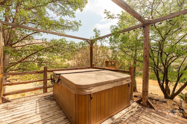 wooden deck with a hot tub