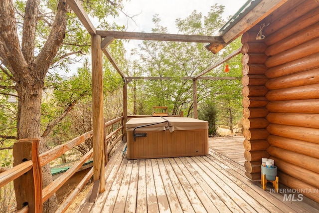 wooden terrace featuring a hot tub