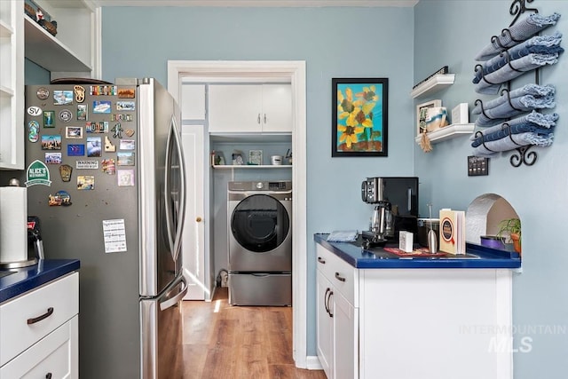 laundry room featuring light wood-style floors and washer / dryer