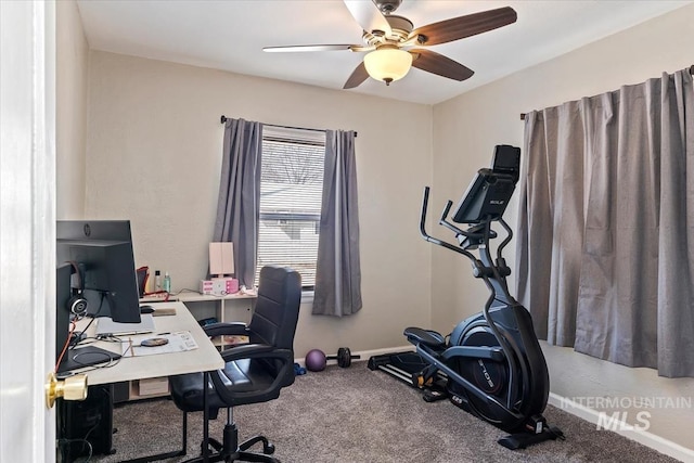 office space with baseboards, carpet, and a ceiling fan