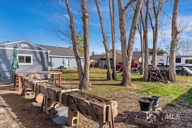 view of yard with a residential view and a vegetable garden