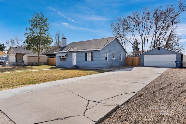 ranch-style home featuring a front lawn, fence, an outdoor structure, a garage, and a chimney