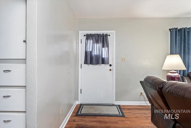 entryway with wood finished floors and baseboards