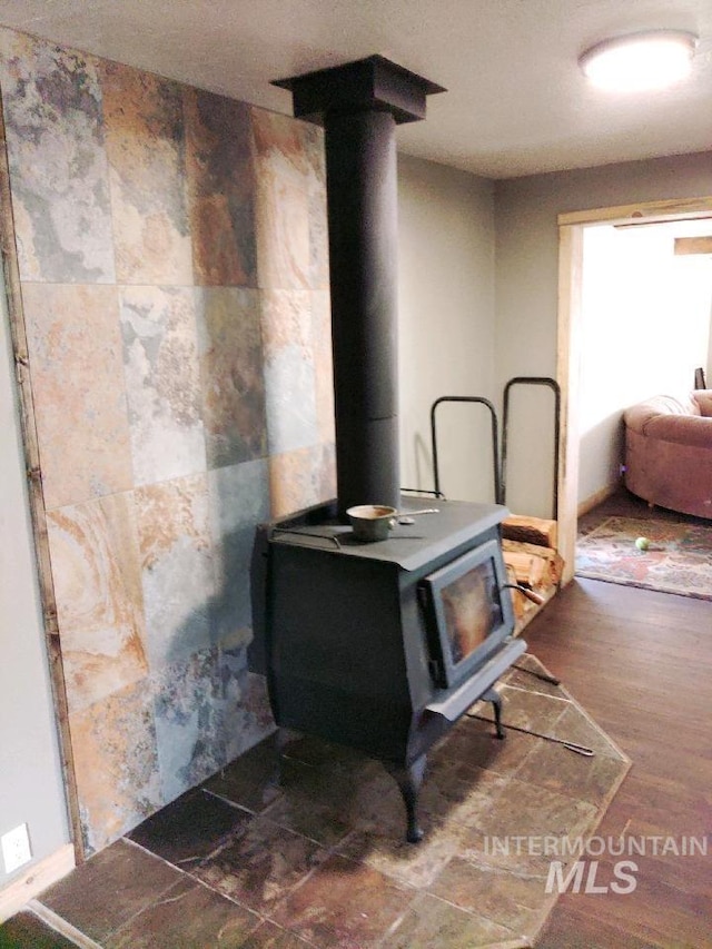 details featuring hardwood / wood-style flooring and a wood stove