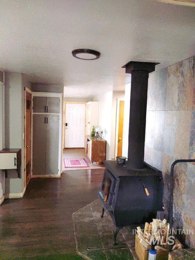 interior space featuring hardwood / wood-style flooring, a textured ceiling, and tile walls