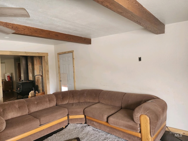 living room with beamed ceiling and ceiling fan