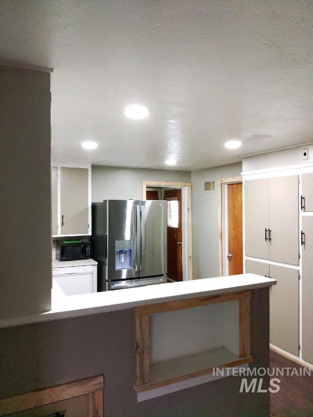 kitchen featuring kitchen peninsula, white cabinets, and stainless steel refrigerator with ice dispenser