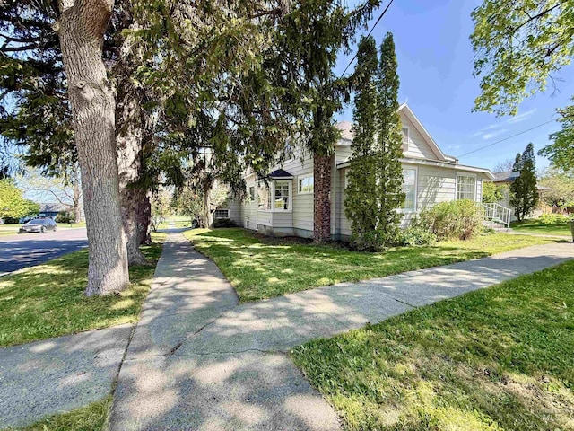 view of side of property featuring a yard