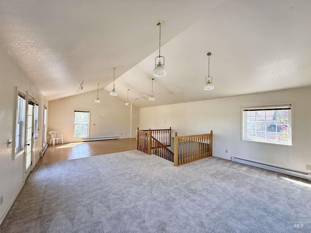carpeted empty room with lofted ceiling and baseboard heating