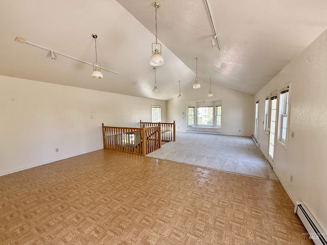 unfurnished room with vaulted ceiling, a baseboard radiator, a baseboard heating unit, rail lighting, and baseboards