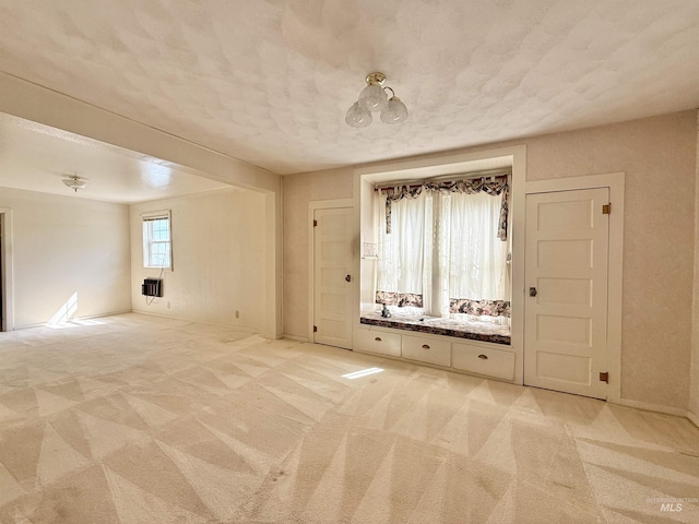 empty room with light carpet and baseboards
