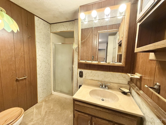 bathroom featuring a shower stall, vanity, toilet, and wooden walls