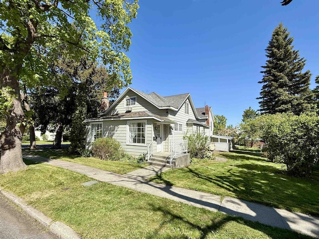 view of front of home with a front lawn and a chimney