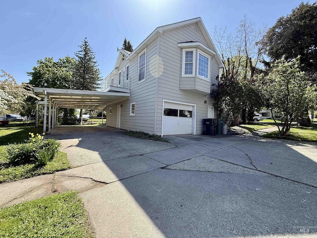 view of home's exterior with concrete driveway and an attached garage