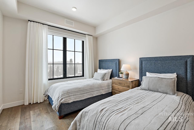 bedroom with hardwood / wood-style floors