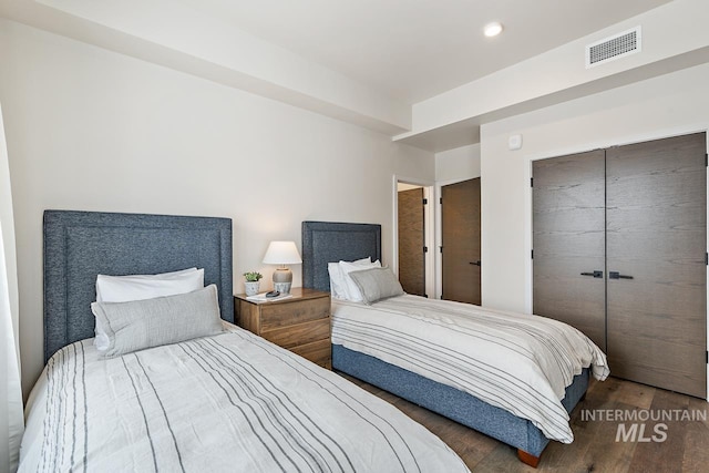 bedroom featuring a closet and dark hardwood / wood-style floors