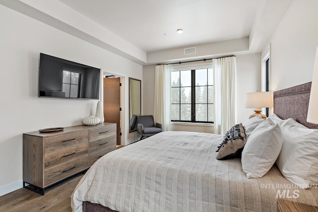 bedroom with dark wood-type flooring