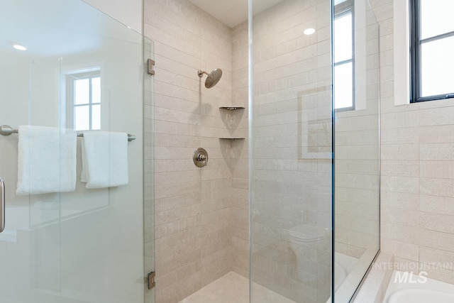 bathroom featuring independent shower and bath