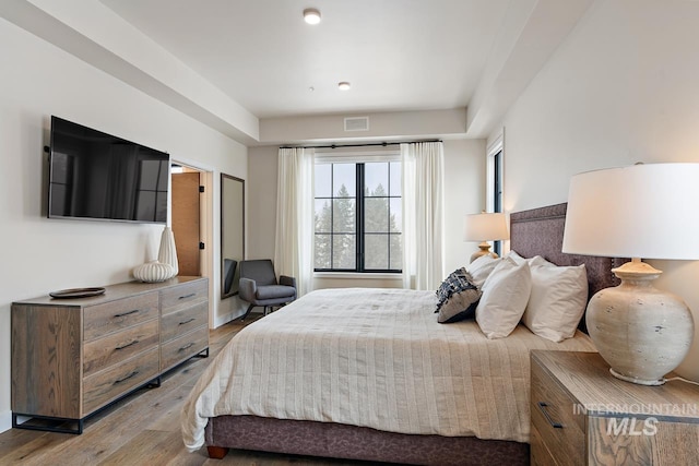 bedroom with hardwood / wood-style flooring