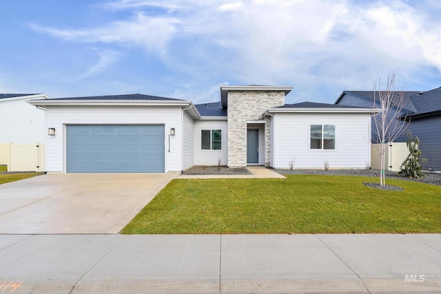 view of front of property with a front yard and a garage