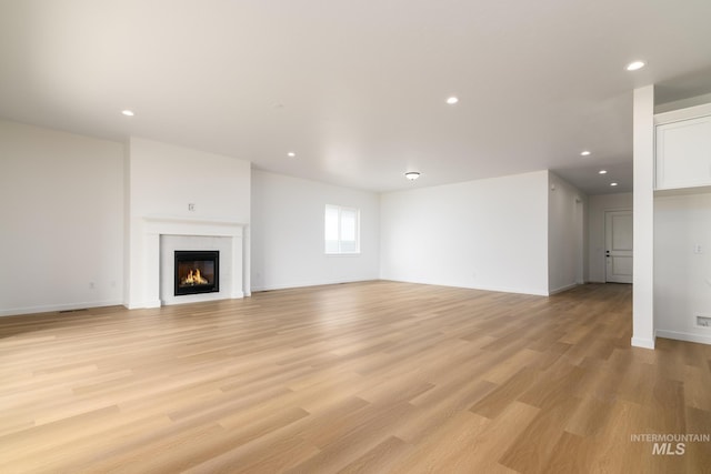 unfurnished living room featuring light hardwood / wood-style floors