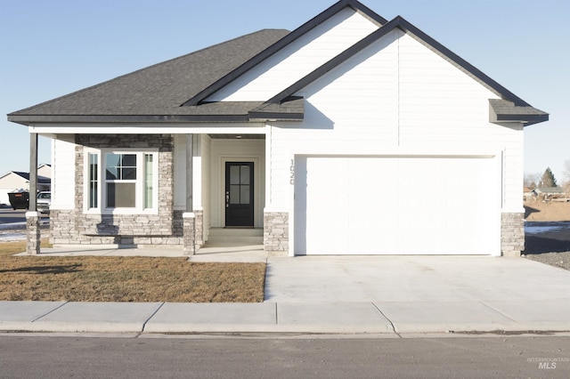 view of front of house featuring a porch and a garage