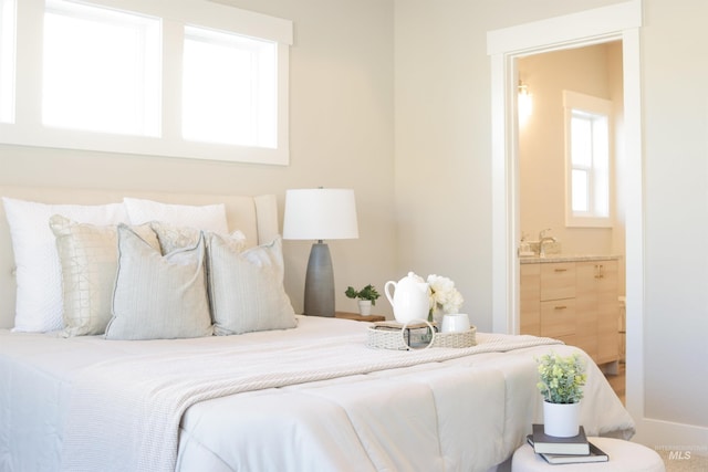 bedroom with multiple windows and ensuite bathroom