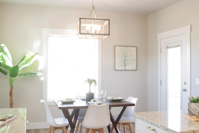 dining area featuring a notable chandelier, hardwood / wood-style flooring, and a wealth of natural light