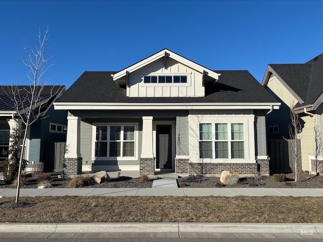 view of front of house with board and batten siding and brick siding