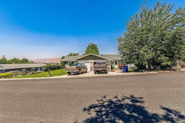 view of front of home with a mountain view and a garage