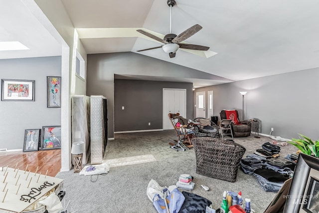 living room with ceiling fan and vaulted ceiling