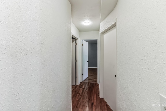 hallway with dark hardwood / wood-style flooring