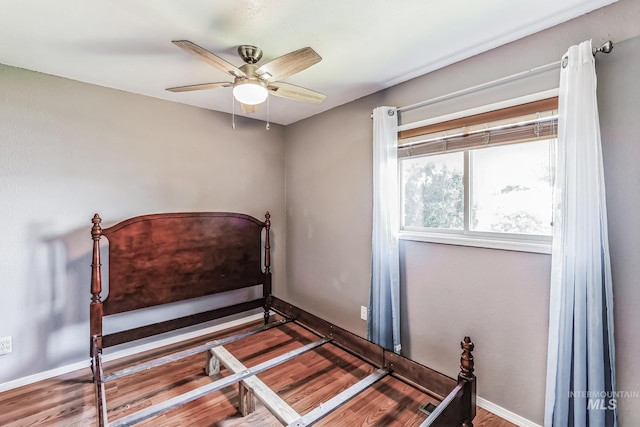 bedroom with wood-type flooring and ceiling fan