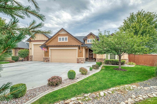 craftsman inspired home with a garage and a front yard