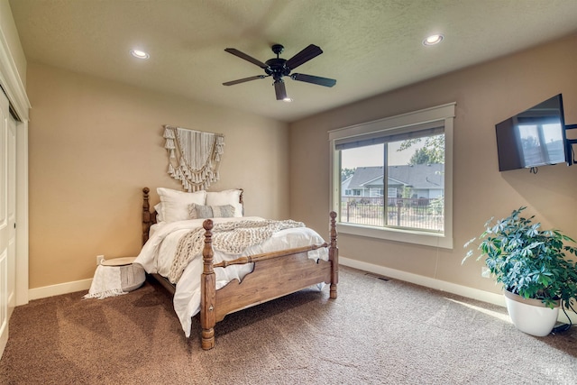 carpeted bedroom with a closet and ceiling fan