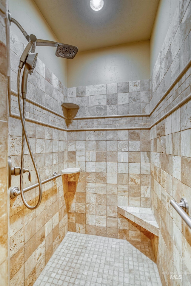 bathroom with a tile shower