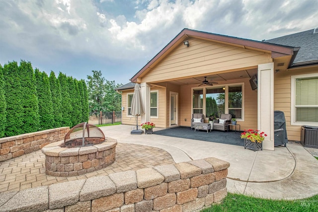 exterior space with ceiling fan, a patio area, and an outdoor living space with a fire pit