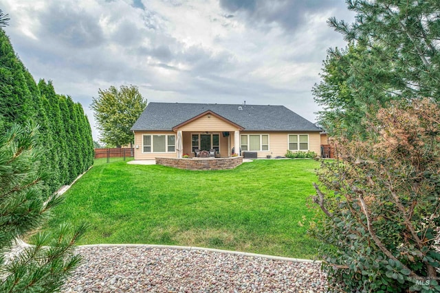 rear view of property with a patio area and a yard